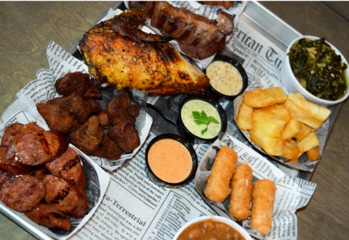 The Roko Sampler lets diners try a little bit of everything, including smoked sirloin, sweet and spicy sausages, fried pork, a quarter chicken and three sides. A variety of dips are also offered.