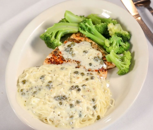 Salmon Bianco ($18.95) A 6-ounce fillet of pan-seared salmon is served with broccoli florets and angel hair  pasta and topped with lemon and caper cream sauce. 