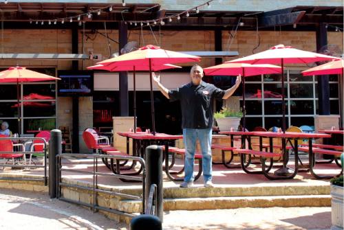 Co-owner Charles Milligan stands on the patio at Docu2019s Backyard.