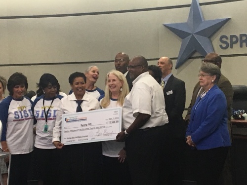Spring ISD board members accept a donation from Spring ISD Education Foundation on Sept. 11.