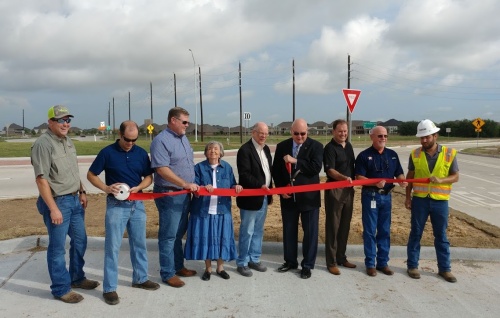 Fort Bend County officials and members of the construction company who built the roundabout prepare to cut the ribbon which officially opened the roundabout.  