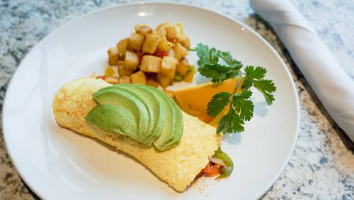 Mexican omelet ($8.99) Egg, sauteed chorizo, tomatoes, bell peppers, jalapenos and cheese are topped with sliced avocado.
