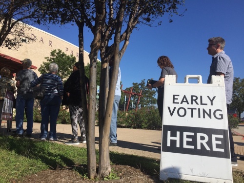 Voters line up outside the polling location in the Cedar Park Public Library Oct. 26.