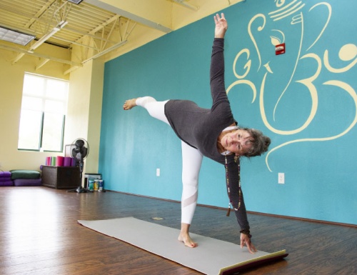 Beth Egbert of Be Happy Yoga demonstrates a pose in the Moksha Yoga and Pilates studio in Georgetown. 