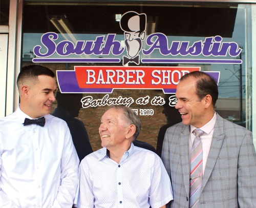 From left: Matthew, Bob and Tom Wandersee stand in front of South Austin Barber Shop.