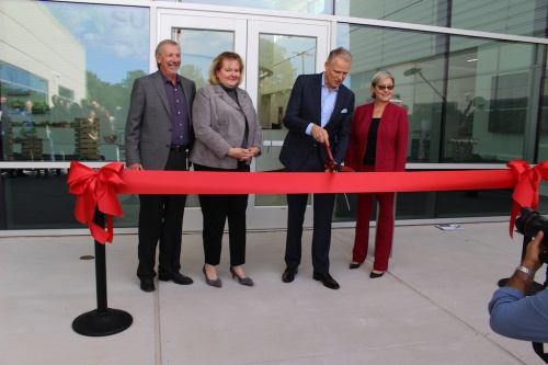 CEO Heiner Markhoff cuts the ribbon at the SUEZ Water Technologies & Solutions ribbon cutting ceremony. 