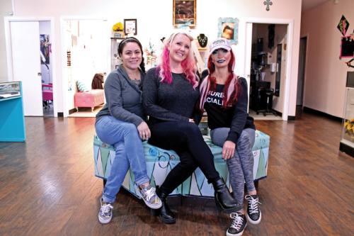 Kimberly Matthews (center) and her staff strive to make The Pin Cushion a welcoming and comfortable environment for clients. Berly has been in the body modification industry for more than a decade.