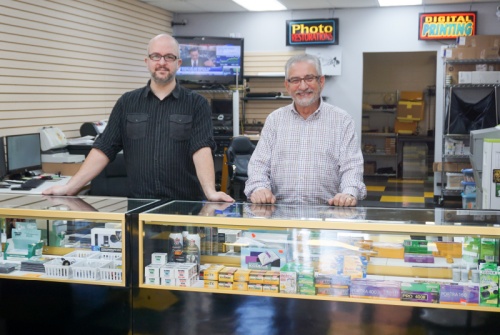 Kingwood Photo Lab store manager Dylan Wilson (left) and owner Steve Khalaf run the shop.