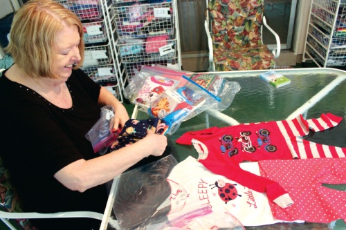 Linda Hunter, Austin chapter co-president, pairs pajamas and books for local children.