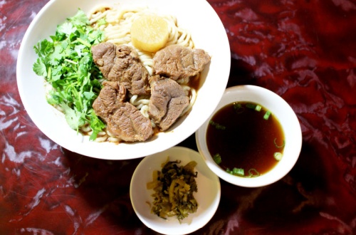 Beef dry noodle ($8.95) is noodles tossed in a rich, homemade sauce; beef, cilantro and daikon radish. The dish is served with a side of mustard cabbage and beef broth.