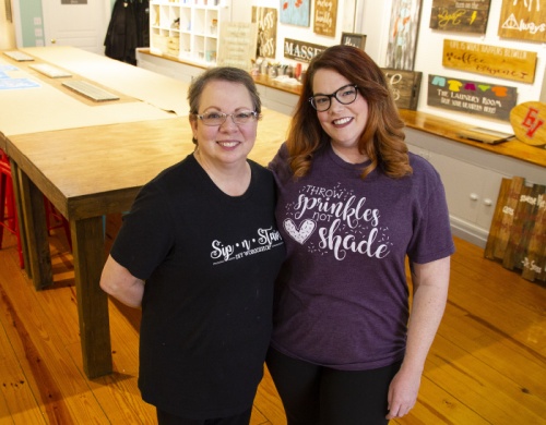 Brenda Massey, left, and Emily Hampton run their businesses in a shared space on the Georgetown Square.