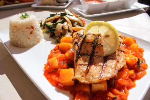 Salmon tropical ($18)nThis plate features grilled salmon served on a tropical mango salsa with grilled vegetables and white rice.