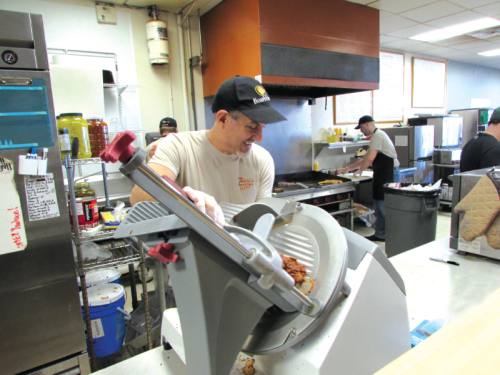 Tucciu2019s SouthSide Subs owner David Tucci slices Boaru2019s Head Cajun turkey.