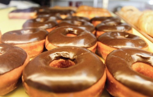 Customers can find chocolate-glazed doughnuts and more at Nathalieu2019s Donuts in Cedar Park. Some other flavors include Oreo and apple fritter doughnuts.