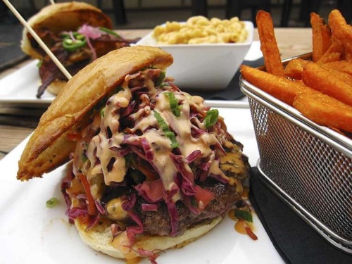 The Aloha Burger at Muck & Fuss Craft Beer and Burgers contains grilled pineapple relish, honey chili sauce, red cabbage slaw and sweet and spicy mayo. Try it with a side of sweet potato fries. 