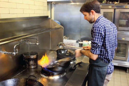 Chef Jeff Brown of East Austin Chinese restaurant Old Thousand prepares a dish at the wok.