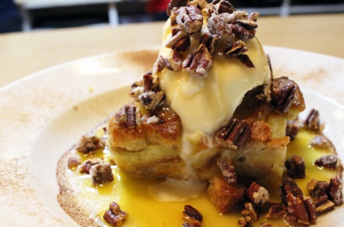 The Rum Raisin Bread Pudding is topped with sugared pecans, rum sauce and French vanilla ice cream.