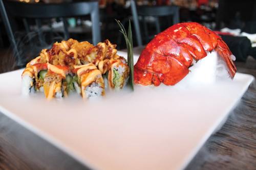 Kissy Suzuki ($28) This u201csmokingu201d roll is filled with lobster tempura and asparagus topped with yellowtail, habanero tobiko and eel sauce.