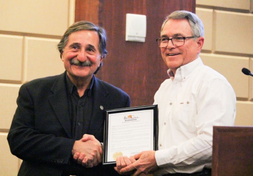 Bee Cave Mayor Monty Parker (right) recognizes Hill Country Rolling Sculpture Car Show creator Dean Mericas during the Jan. 22 City Council meeting. 