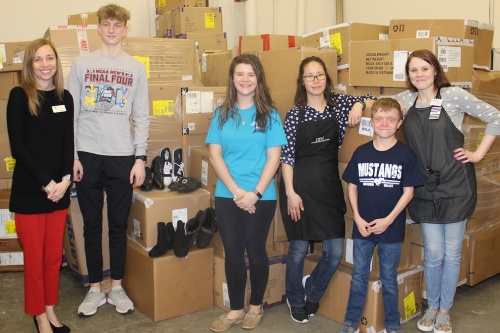 Delivering 88 boxes of shoes to DSW Designer Shoe Warehouse from left are Comal ISDnAssistant Superintendent of Curriculum & Academics Kerry Gain, Smithson Valley High School junior Owen Woodard, Smithson Valley High School junior Abigail Redin, DSWu00a0Sales Clerku00a0Christie Fealy, SmithsonnValley Middle School seventh grader Grayson Cook and DSW Sales Clerk Stacey Laird.