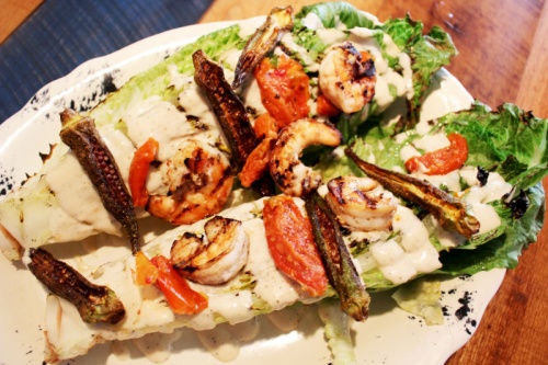 The grilled caesar with shrimp ($14) at Tricky Fish is served on romaine hearts with tomatoes, okra and croutons.