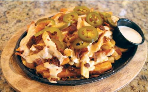 Loaded Cheese Fries ($10) are topped with melted cheese, queso, bacon and jalapenos.