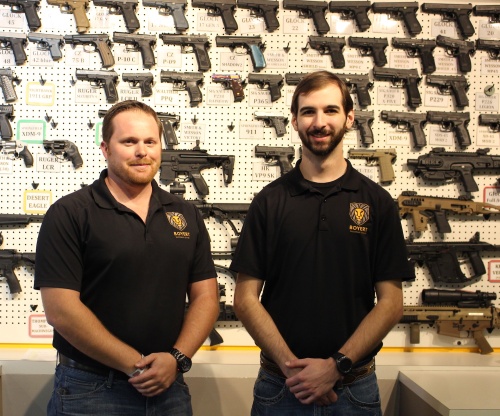 General Manager Curtis Alberts (left) and Assistant General Manager Cameron Sanders showcase available firearms.