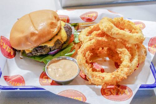 The restaurant offers its signature cheeseburger and onion rings.
