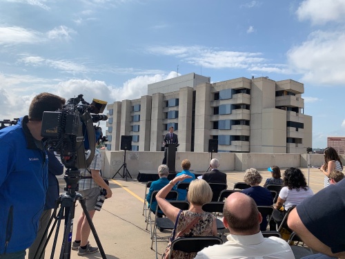 Central Health CEO Mike Geeslin speaks at a May 15 news conference announcing plans to demolish the Brackenridge hospital tower, visible in the background. 
