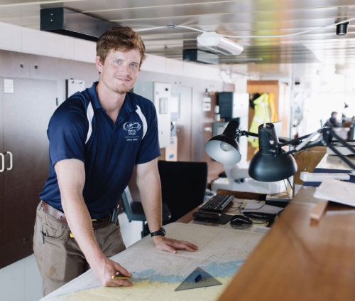 Coltan Coleman, League City resident and Mercy Ships volunteer, studies charts aboard the Africa Mercy in Guinea, West Africa.