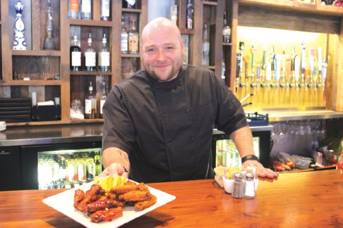 Backspin Sports Bar Executive Chef Joseph Farner serves up chicken wings.