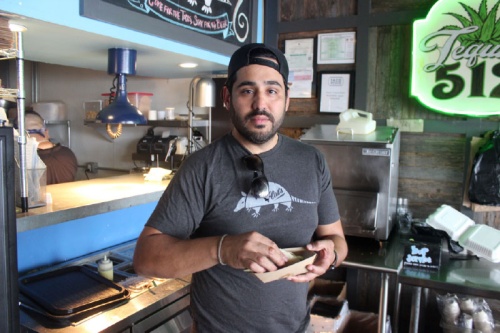Owner Simon Madera tries a taco from the kitchen at the Taco Flats location on Burnet Road.