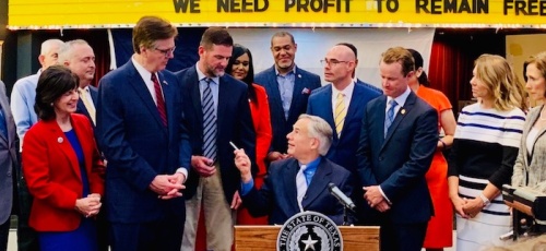 Texas Gov. Greg Abbott (center) signed several pieces of legislation into law June 13 dealing with flood mitigation in Texas.
