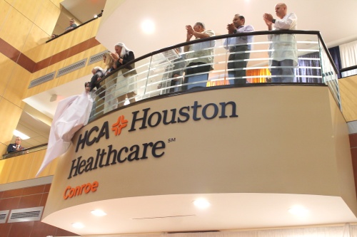 The HCA Houston Healthcare Conroe board of trustees unveils the hospital's new sign June 25.