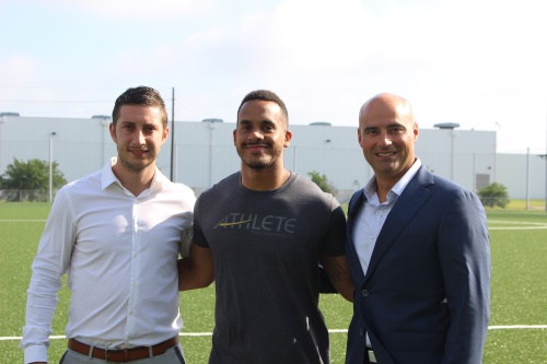 From left, Micheu00e1l Cahill, vice president for performance and sports science with Athlete Training and Health; Chris Slocum, athletic performance director with Athlete Training and Help; and Heath Rushing, CEO of Memorial Hermann Hospital Katy; stand on field.
