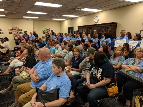Members of the Pflugerville Educators Association pack the district's board room June 25 to advocate for higher compensation increases.
