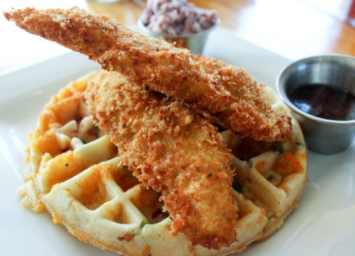 Chicken and waffles ($11.25) Fried chicken and jalapeno-bacon cheddar waffles are served with blueberry butter and Cajun syrup.