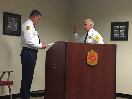 Michael Gosselin (right) takes the oath of office at a swearing-in ceremony July 20 to become Klein Volunteer Fire Department's first paid chief. 