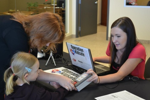 A child goes through the fingerprinting process at an Operation Kidsafe program.