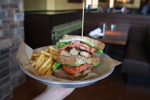 The Pork Belly BLT is topped with candied bacon, lettuce, tomato and black pepper mayo. 