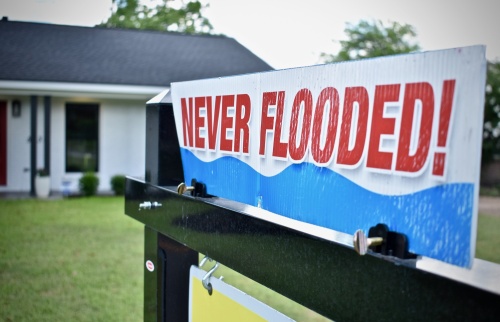 A home for sale in the Willowbend area of Houston promotes its lack of flood damage.