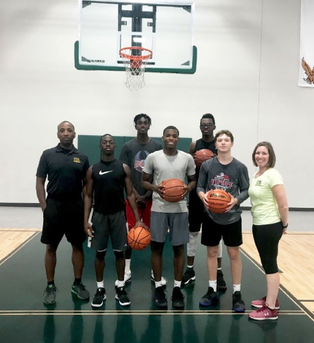 Mathis Crowder and Shira Ackerman, pictured above with some of the members of the Creating Young Minds Academy, provide personal and academic mentorship to young men as well as athletic development.