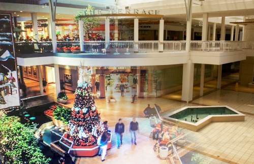This illustration blends two photos of nCollin Creek Mall, once filled with shoppers and now nsitting vacant.