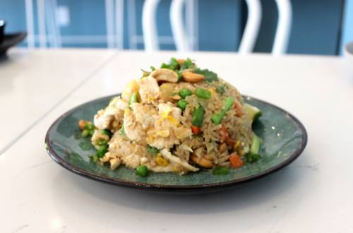 Spoon + Forku2019s pineapple fried rice, served with chicken, green onions and cashews, is a customer favorite.