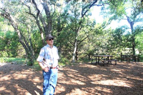 Bob Ayres, a Shield Ranch co-owner and president and CEO of the Shield Ranch Foundation, stands at the area used as the El Ranchito campground.