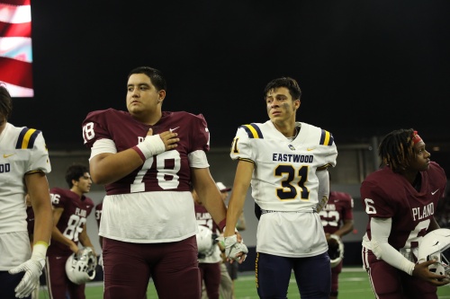 Plano ISD defensive line Dominick Herrera holds hands with El Paso Eastwood defensive back Nathan Carranza during the national anthem. Carranza visibly holds back tears.