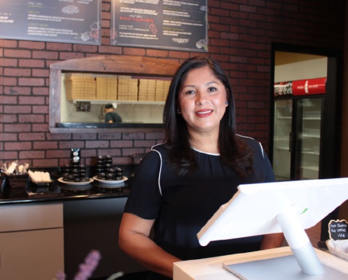 Owner Adelmira Salazar behind the counter at Cirau2019s Pizza.