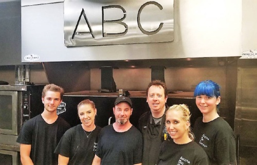Mark Nichols [fourth from left] and his staff take great pride in service and quality food at Arizona BBQ Company.