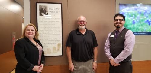 From left: Rita Sullivan of Frost Bank, first customer Keith Cartwright and branch manager Marco Galvan pose at the new Conroe location.