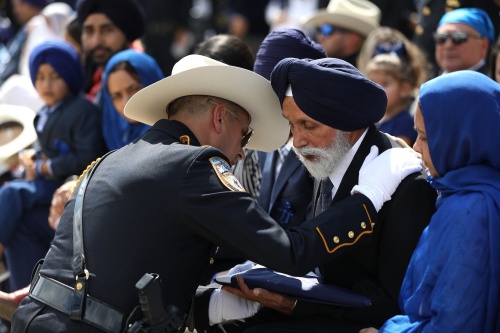 Public officials, law enforcement officers and members of the Sikh community mourn the loss of Deputy Sandeep Dhaliwal Oct. 2 at the Berry Center. 